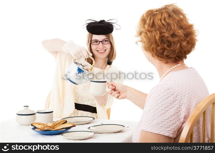 Teen girl pouring tea for her mother at a Mother&rsquo;s Day tea party.