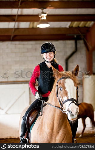 Teen girl riding horse