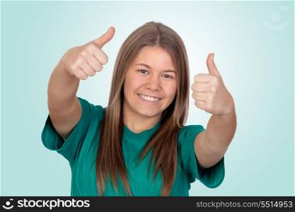 Teen girl saying OK isolated on green background