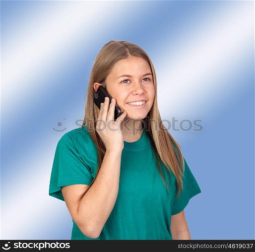 Teen girl speaking by mobile isolated on blue background