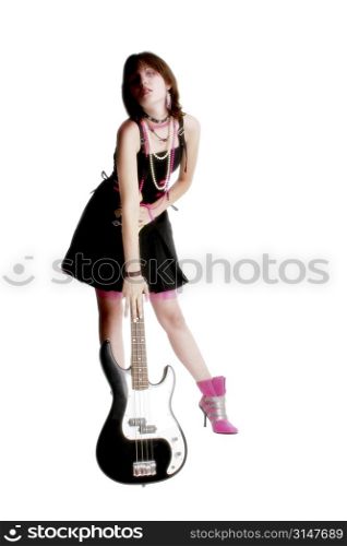Teen girl standing with electric bass guitar.