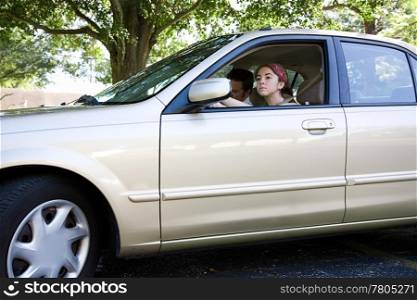 Teen girl taking a car for a test drive. Could also be driving test for license.