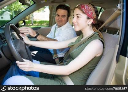Teen girl taking driving lessons from an instructor or her father.