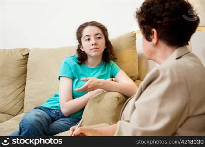 Teen girl talking to a female counselor. Could also be job or college interview.