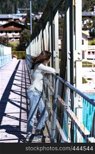 teen girl walking on a bridge, Auronzo di Cadore at the italy