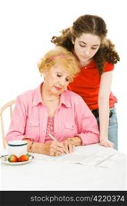 Teen girl watching her grandmother fill out an absentee ballot. Isolated on white.