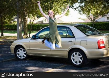 Teen girl with new car jumps for joy.