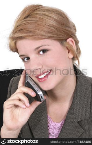 Teen girl with smile speaking on cellphone.