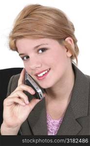 Teen girl with smile speaking on cellphone.