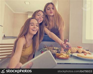 teen girls best friends selfie photo having lunch. teen girls best friends selfie photo having lunch eating at kitchen