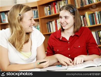 Teen girls studying together in the school library.