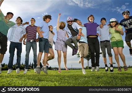 Teen group jumping in park