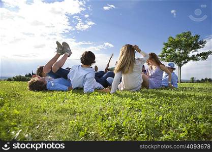 Teen group laying on grass in park