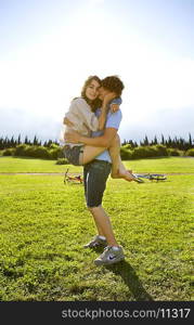 Teen lovers hug in park