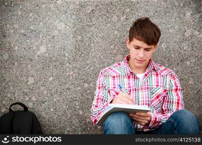 teen with notebook, selective focus on face