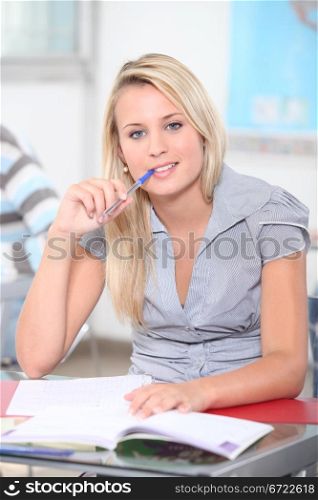 Teen with pen in mouth