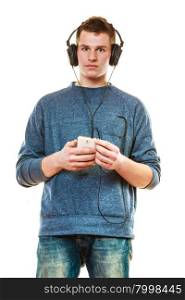 Teenage and technology concept. Young man casual style with headphones smartphone listening music isolated on white
