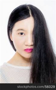 Teenage Asian American girl with hair covering half face