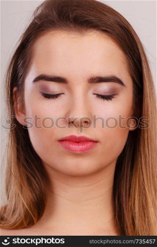 Teenage beauty concept. Closeup portrait of young teenager woman having neutral face expression.. Closeup portrait of young teenager woman.