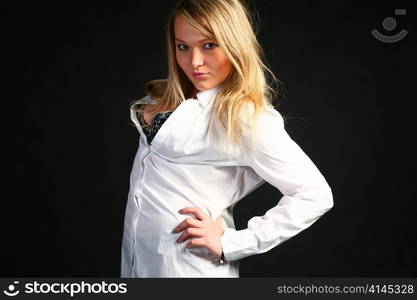 teenage blond girl portrait, studio shot on dark