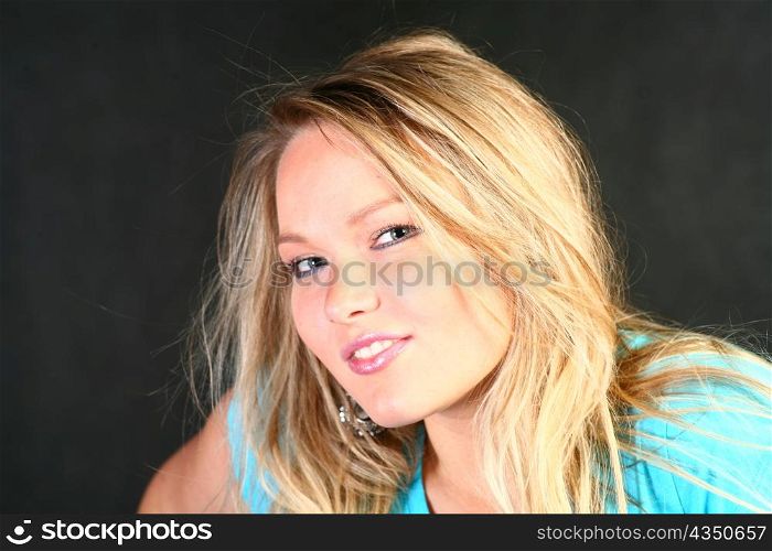teenage blond girl portrait, studio shot on dark