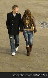 Teenage boy and a teenage girl walking on the road