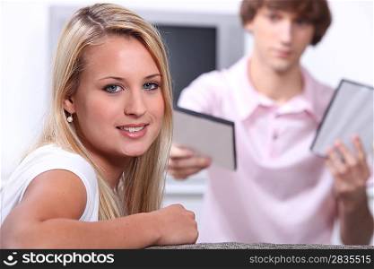 Teenage boy and girl choosing DVD