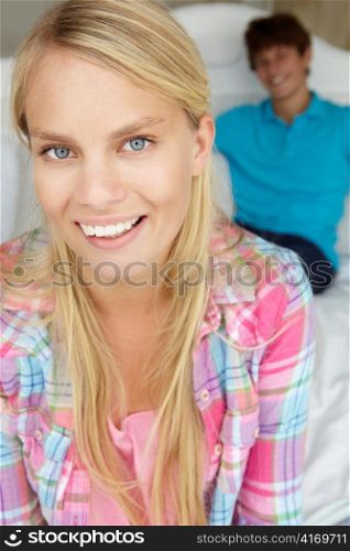 Teenage boy and girl in bedroom