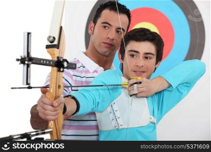 Teenage boy archery lesson