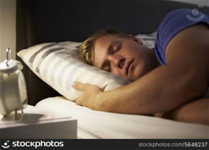 Teenage Boy Asleep In Bed At Night