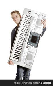 teenage boy carries keyboard in studio against white background