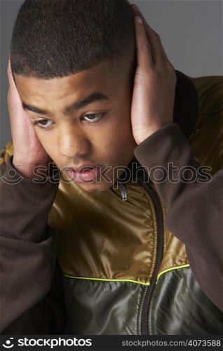 Teenage Boy Covering Ears With Hands
