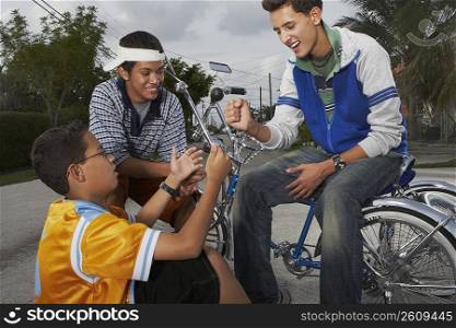 Teenage boy gesturing to his two friends and smiling