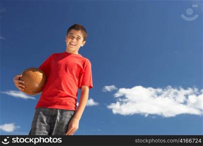 Teenage boy holding football