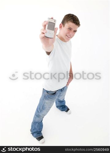 Teenage boy holding up cellular phone and smiling