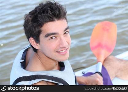 Teenage boy kayaking