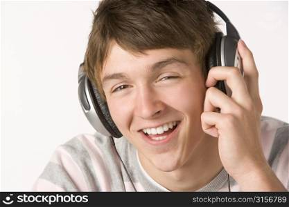 Teenage Boy Listening To Music On Headphones