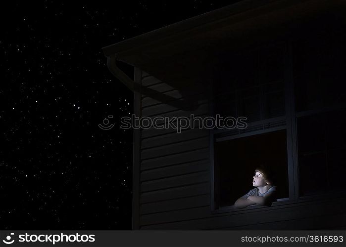 Teenage boy looks up at night sky