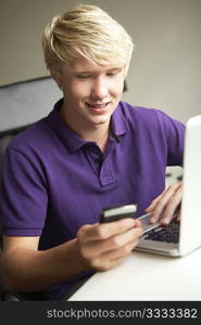 Teenage Boy Lying In Bedroom Drinking