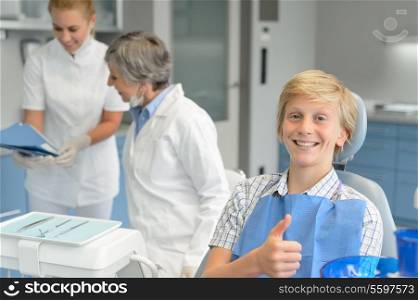 Teenage boy patient teeth checkup at dental surgery dentist woman