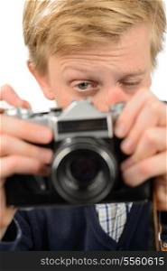 Teenage boy photographing through retro camera against white background