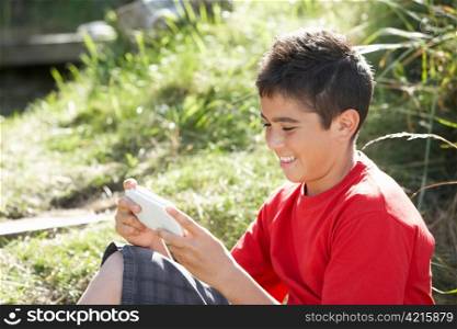 Teenage boy playing with computer game
