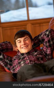 Teenage Boy Relaxing On Sofa