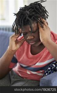 Teenage Boy Sick With Headache At Home