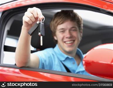 Teenage Boy Sitting In Car Holding Car Keys