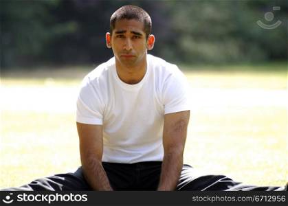 teenage boy sitting in park relaxing