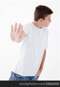 Teenage boy standing with hand up