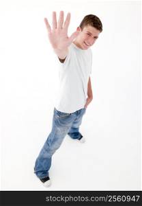 Teenage boy standing with hand up smiling