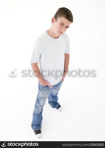 Teenage boy standing with hands in pockets