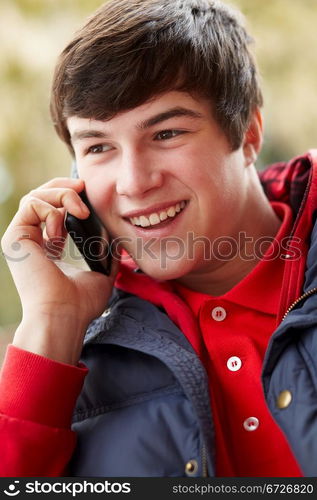 Teenage Boy Talking On Smartphone Wearing Winter Clothes